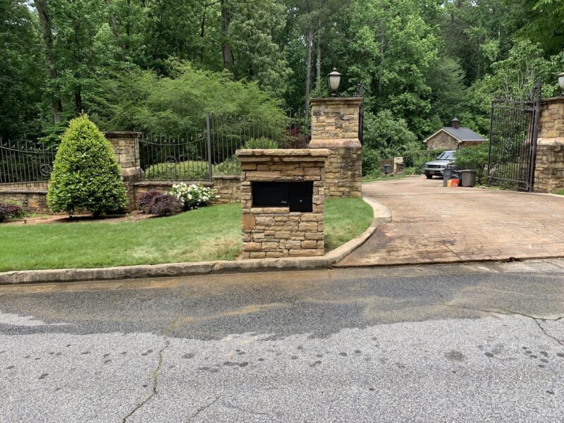 Custom natural stone 'Amazon Vault' mailbox with hidden heavy-duty bank vault door built by Atlanta Waterscapes in Tucker, GA